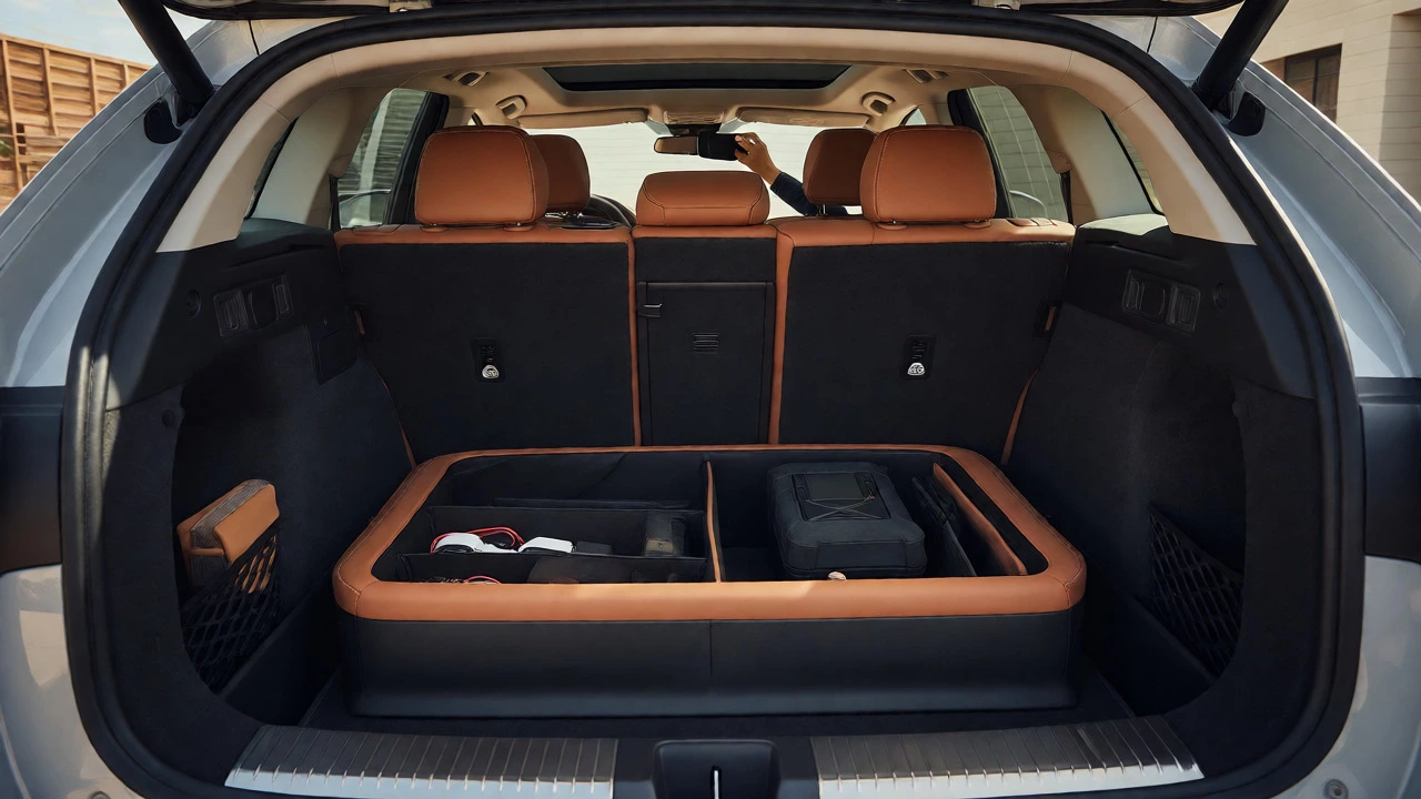 Organized car trunk with leather storage box and magnetic phone mount visible.